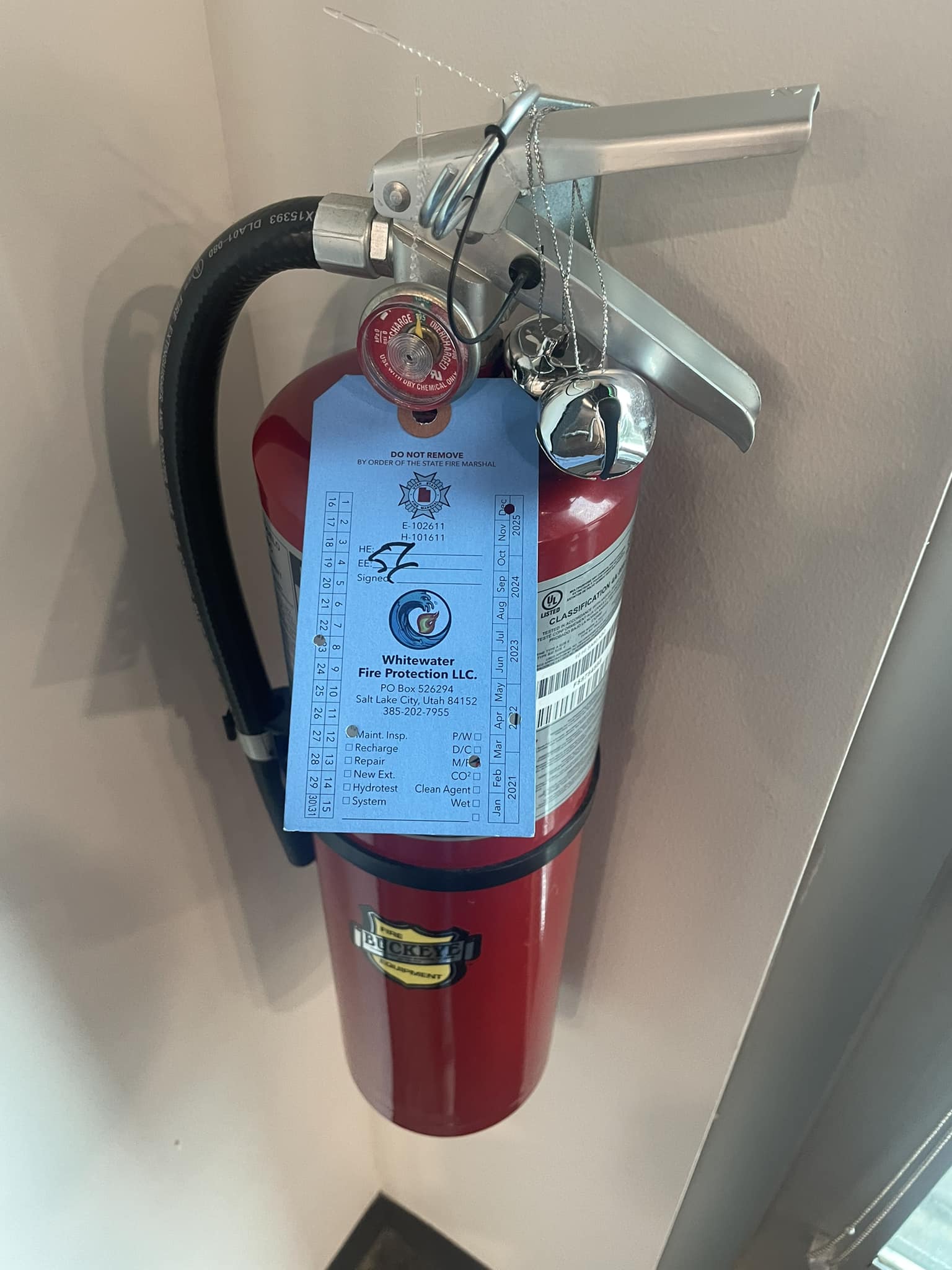 Fire extinguisher with Whitewater inspection tag